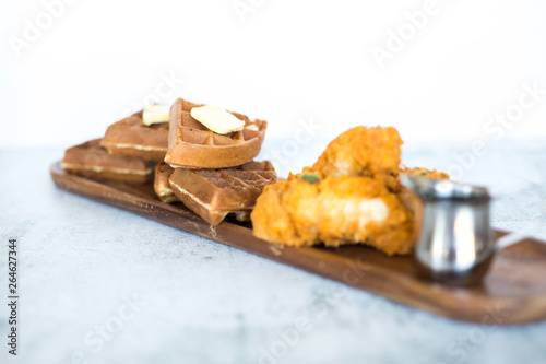 Chicken and Waffles on Wooden Plate 