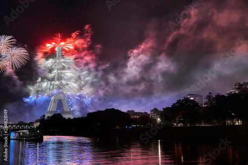 Fototapeta Naklejka Na Ścianę i Meble -  Fireworks show on the eiffel tower displaying the French national flag in celebration of bastille day, quatorze julliet the 14th of july