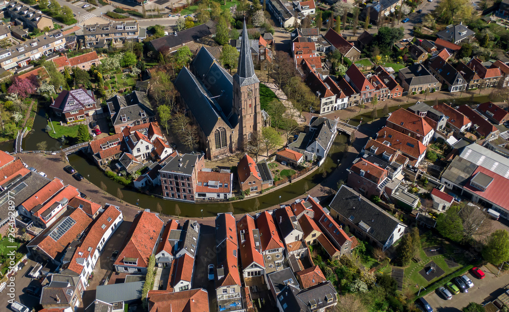 Aerial historic dutch village Maasland with central church and canal curving around - obrazy, fototapety, plakaty 