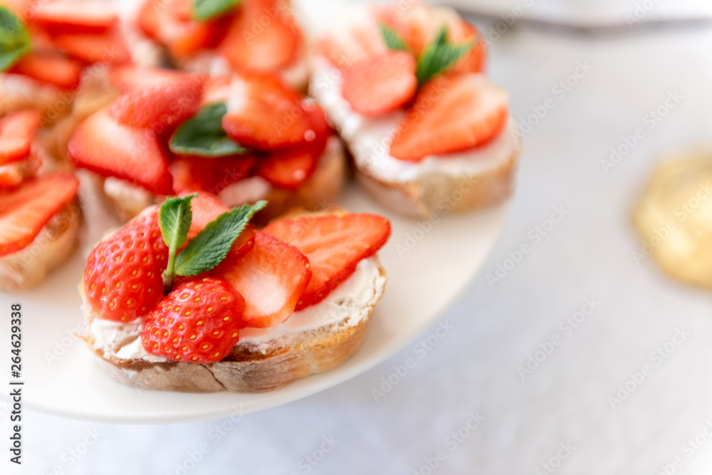 New trendy appetizers on the holiday table with fresh flowers and cheese.