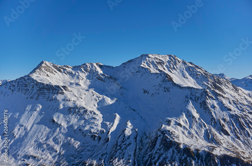 Snow covered mountain with bright blue sky in the Swiss alps 