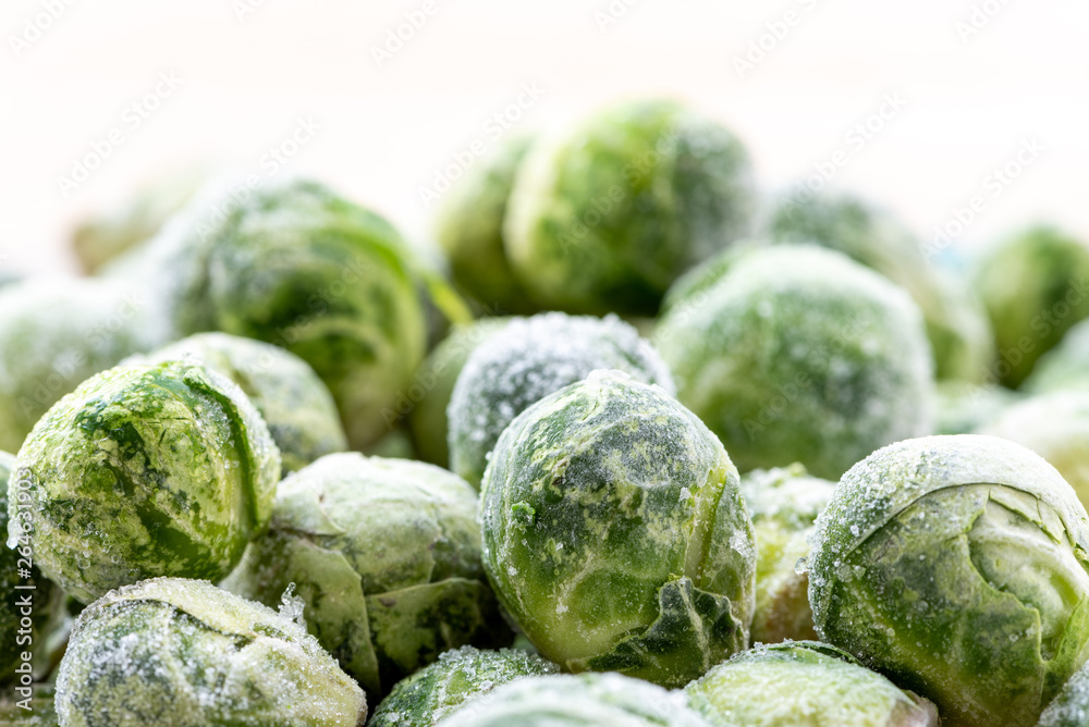 Fototapeta premium A pile of frozen brussels sprouts close up.