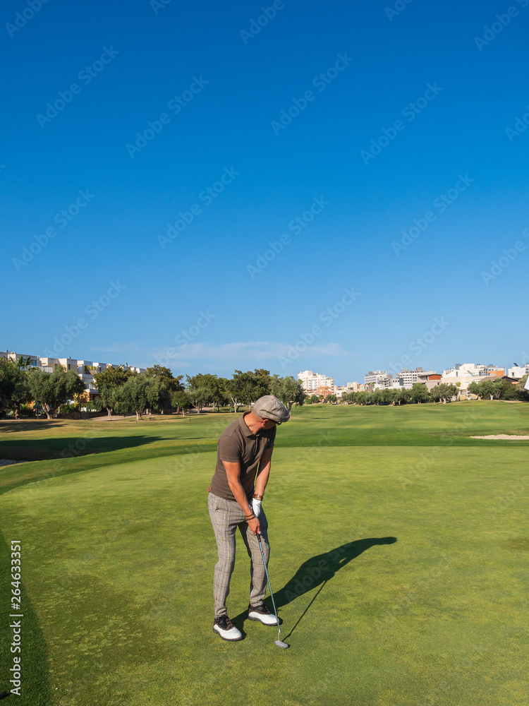 athletic and attractive man playing golf on a sunny day