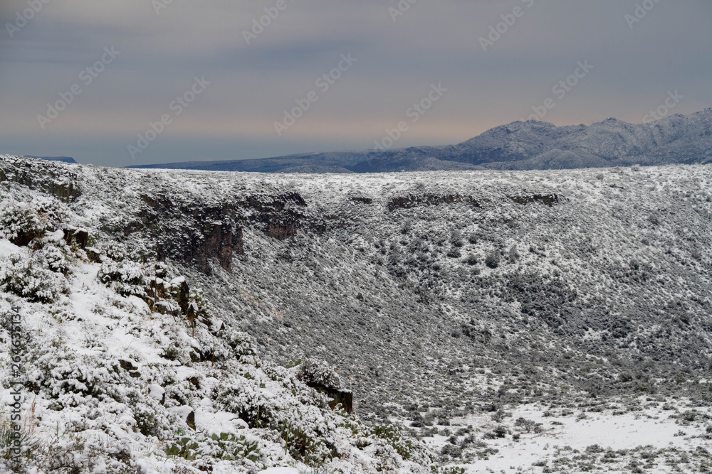 The desert of Arizona covered in snow with distant mountains. The desert of Arizona covered in snow with distant mountains.