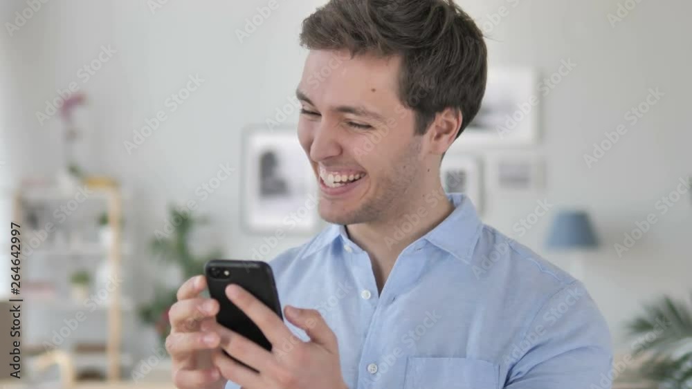 Excited Man Enjoying Success while Using Smartphone Excited Man Enjoying Success while Using Smartphone