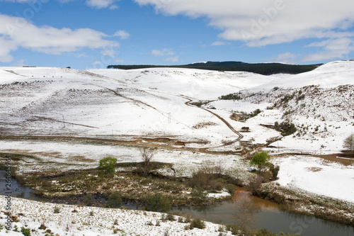 Snow covered slopes around local river nea Drakensbergen, South-Africa photo