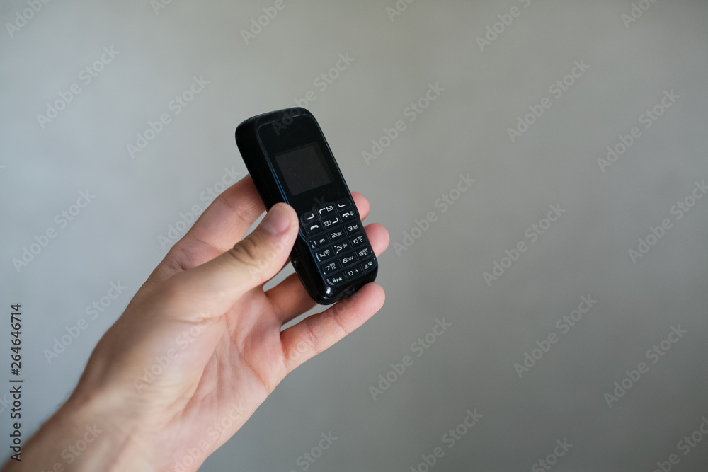 Close-up of man hand holding old black mobile phone Close-up of man hand holding old black mobile phone