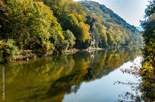 Fototapeta Naklejka Na Ścianę i Meble -  Beautiful autumn landscape is reflected in the mirror mountain river Psekups. Sunny day in esort area with Cockerel rock of Goryachiy Klyuch. Krasnodar region. Excellent natural background.