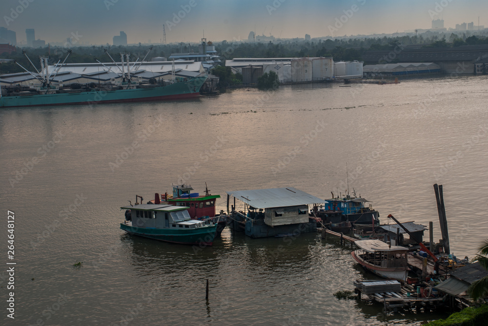 Many boats docked in the Chao Phraya River.