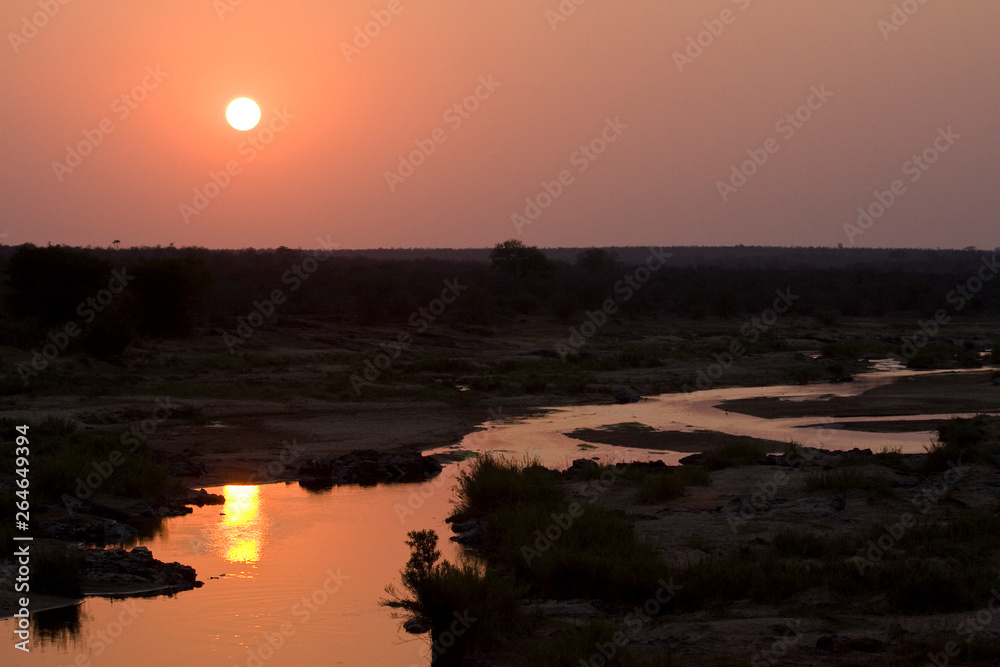 Φωτογραφία Sunset over a red coloured river in Kruger national park, South-Africa