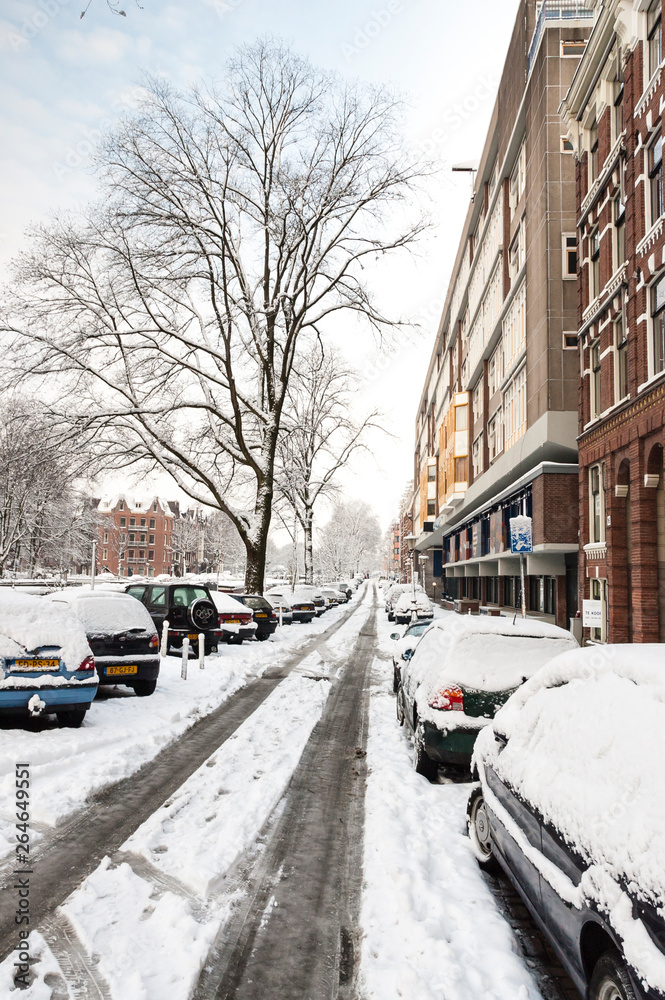 Snow-covered street Hugo de Grootkade in Amsterdam during a cold winter in the Netherlands. Hugo de Grootkade. Snow-covered street Hugo de Grootkade in Amsterdam during a cold winter in the Netherlands. Hugo de Grootkade.