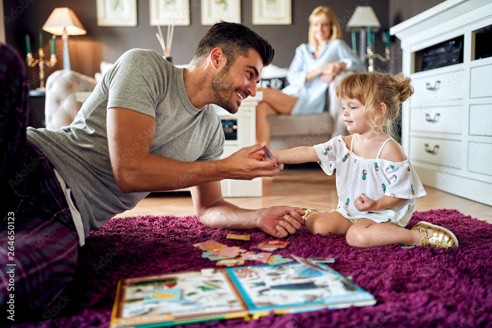 Father with female child playing with puzzles Father with female child playing with puzzles
