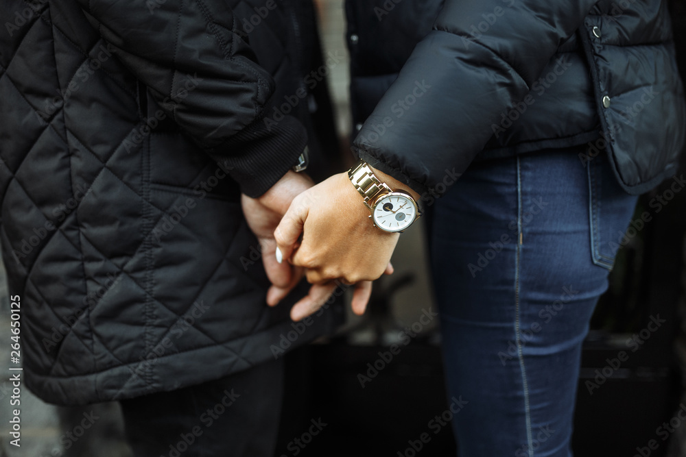 Image of a man holding a girl's hand