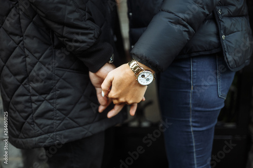 Image of a man holding a girl's hand