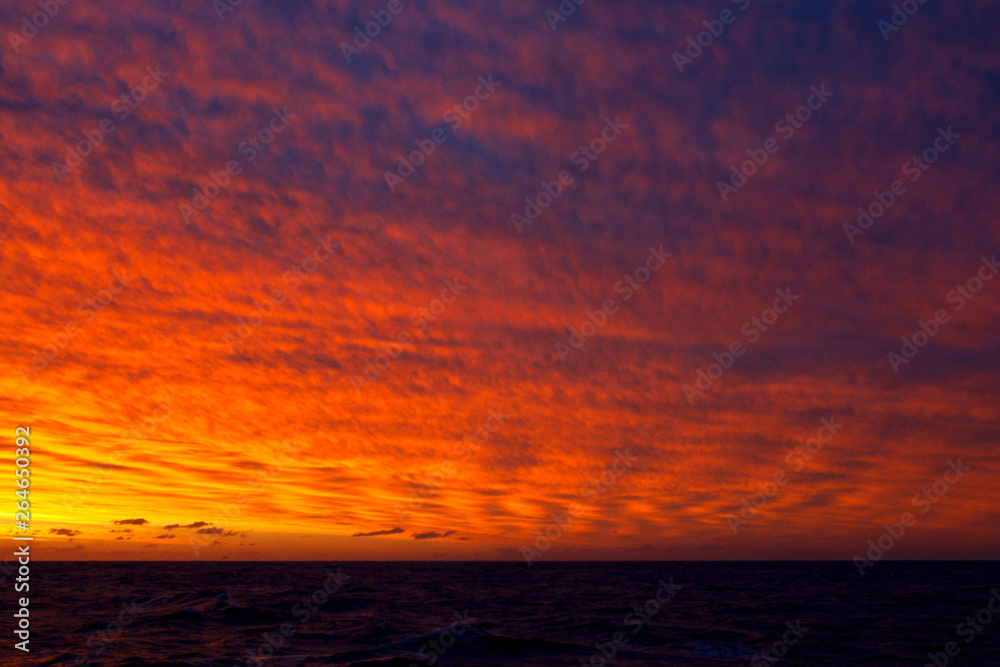 Stunning red colored sunset in the Southern Atlantic Ocean