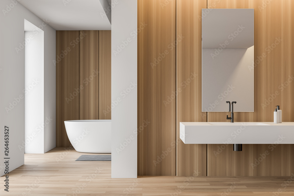 Obraz premium Stylish white and wooden bathroom, tub and sink
