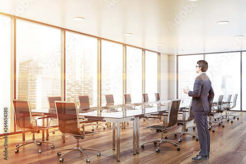 Businessman in panoramic conferece room photo