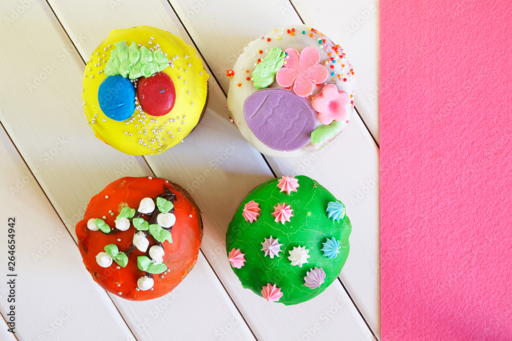 Colorful varied cupcakes - Easter cakes on white and pink background. Country breakfast. Homemade. View from above