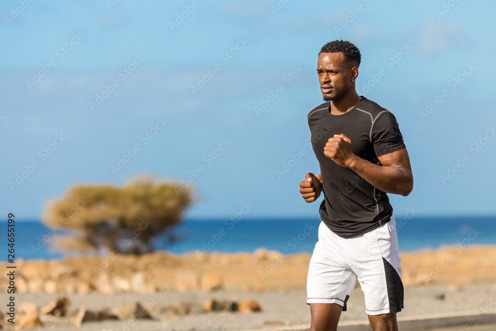 Fototapeta premium Black african american young man running outdoor