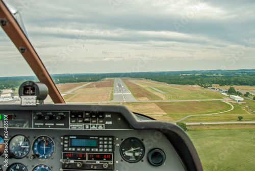 a view from the cockpit of a sports aircraft to the runway of an airfield