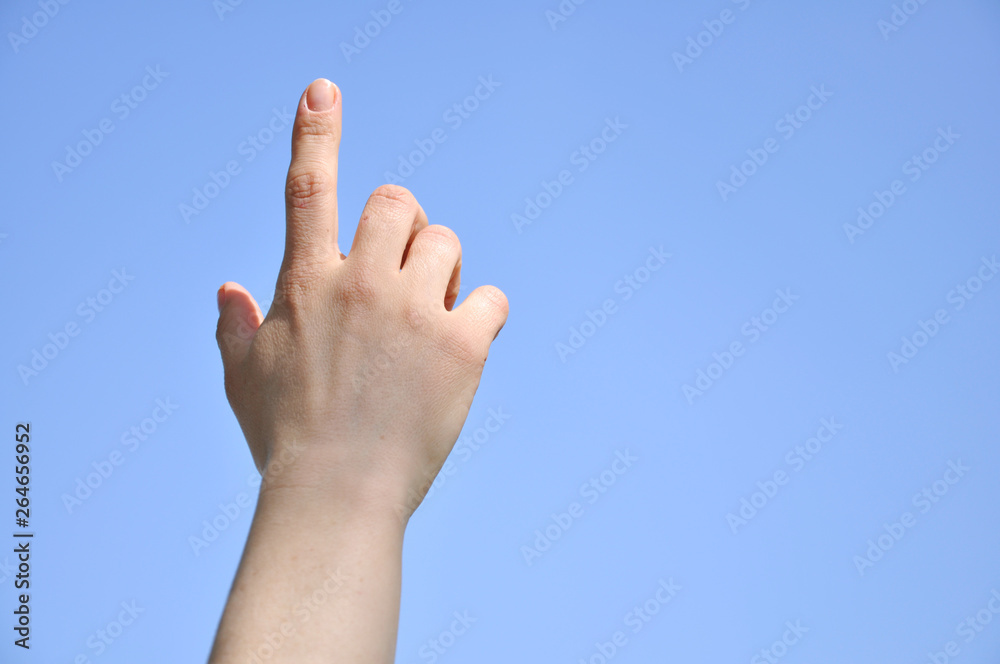Index finger raised up. Man's hand is directed to the sky Index finger raised up. Man's hand is directed to the sky