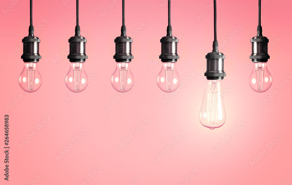 Many hanging lamp bulbs on color background. Symbol of idea and solution Many hanging lamp bulbs on color background. Symbol of idea and solution