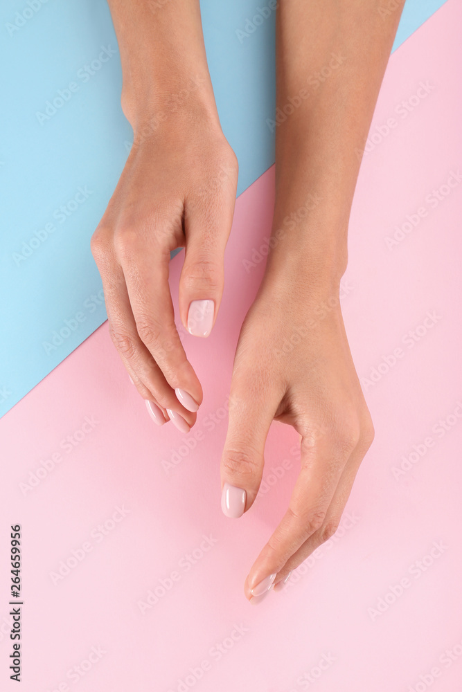 Fototapeta premium Closeup view of woman with beautiful hands on color background. Spa treatment