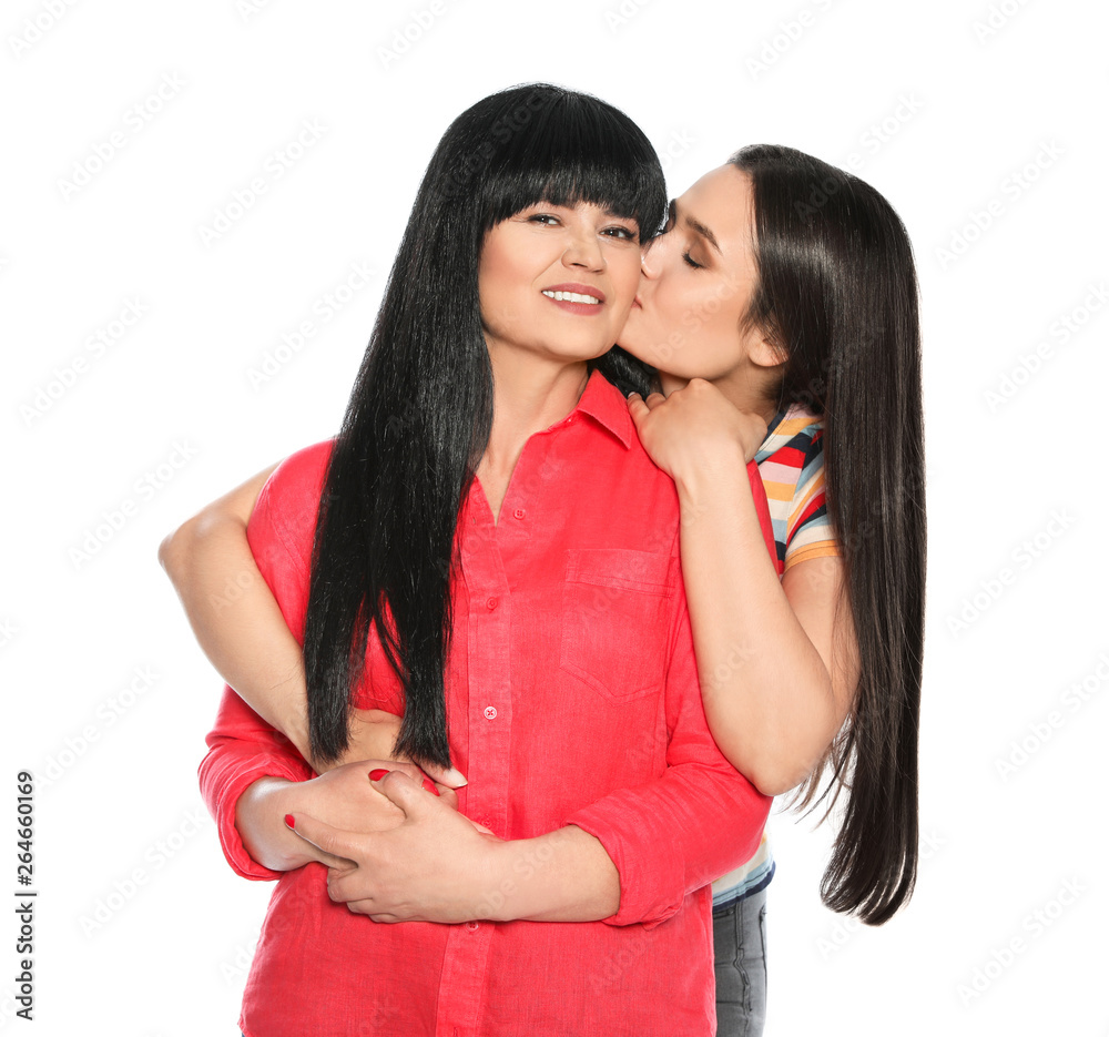 Young woman kissing her mature mother on white background Stock Photo Adobe Stock pic