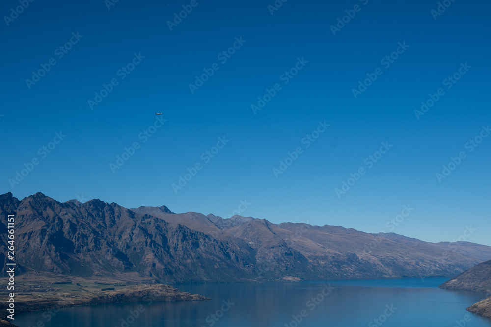 The view looking over Queenstown in New Zealand during summer on a sunny day