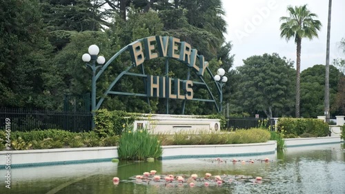 Grand Beverly Hills welcome board facade with a pond, wide shot