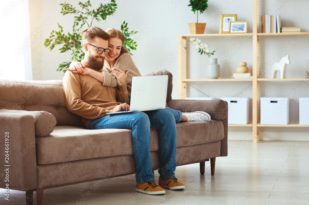 happy couple with laptop computer at home . happy couple with laptop computer at home .