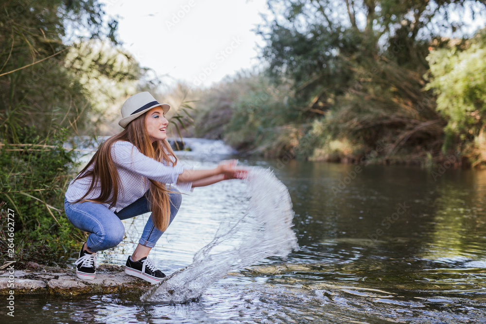 Fototapeta premium Blonde woman enjoys water in a lake