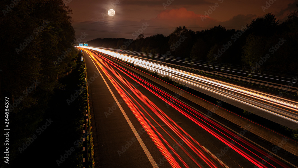 Obraz premium Langzeitbelichtung auf der Autobahn. Nachtlichter, Stadtlichter, Geschwindigkeit, Transport, Traffic, Autos in Bewegung, Fahrbahn, Road