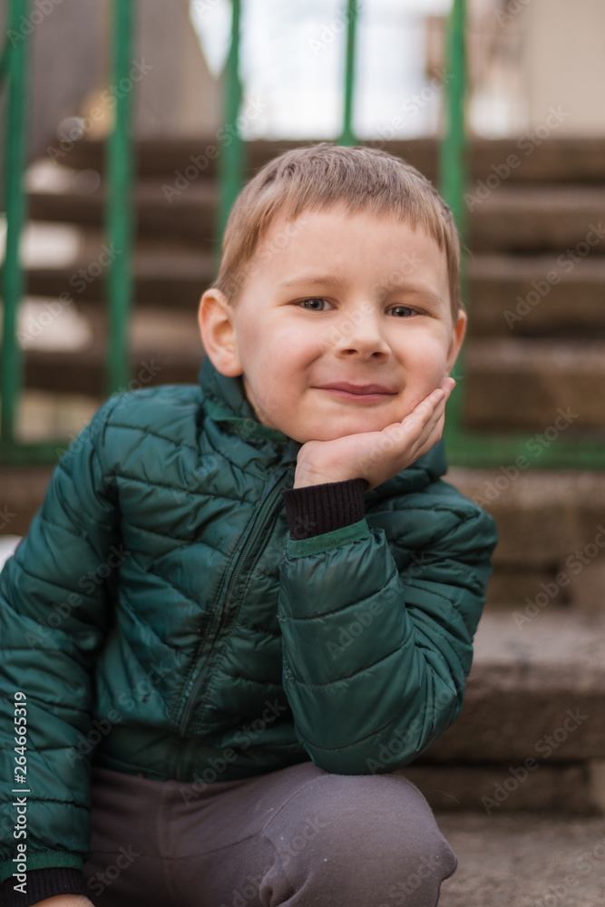 Portrait of a little boy in a jacket on the street. Portrait of a little boy in a jacket on the street.