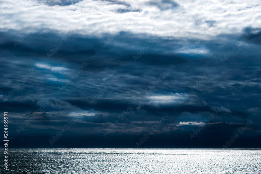 Dark clouds forming above the calm waves of the Atlantic Ocean, Block Island, RI