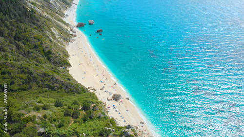 AERIAL: Stunning view from above of a remote white sand beach and turquoise sea. © helivideo