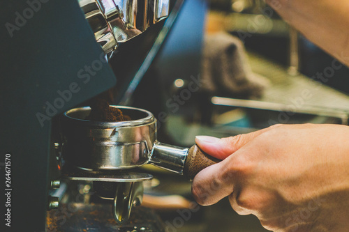 Close-up hands barista making coffee. Barista making fresh coffee. 