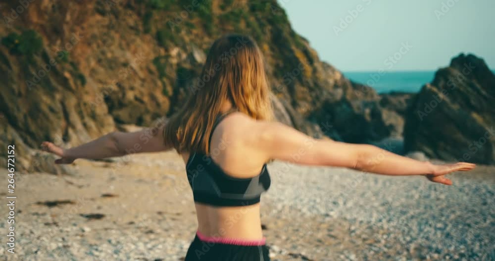 Fitness woman warming uyp for beach workout at sunset Fitness woman warming uyp for beach workout at sunset