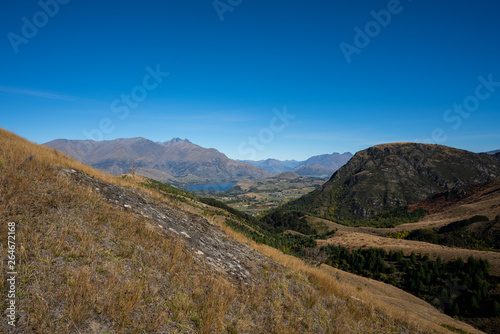The rolling hills of Arrowtown in New Zealand at the start of Autumn