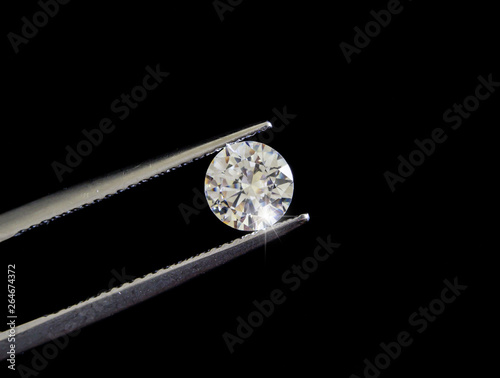 Diamond round shape in tweezers. © virachai