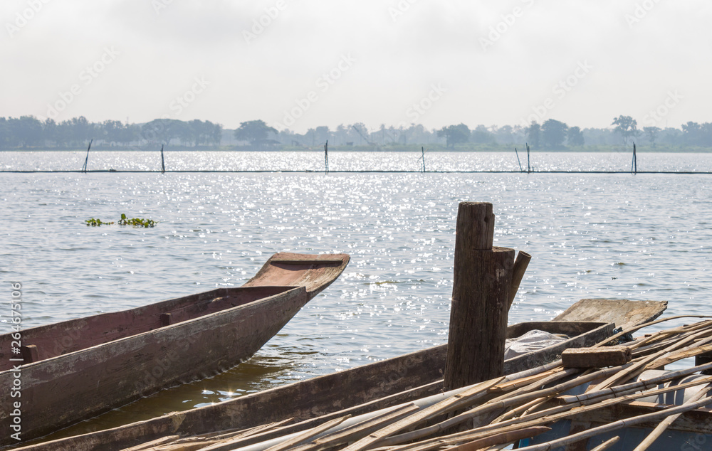 Wood Fishing Boat or Rowboat on Swamp with Wood Boat Pole