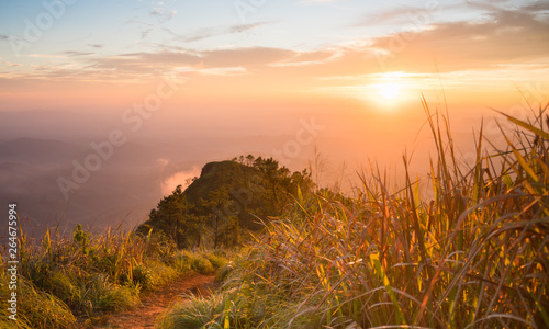 Gold Sunset Light Phu Nom at Phu Langka National Park Thailand with Fog on Sky Wide
