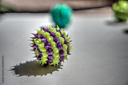 green and purple striped ball with spikes photo