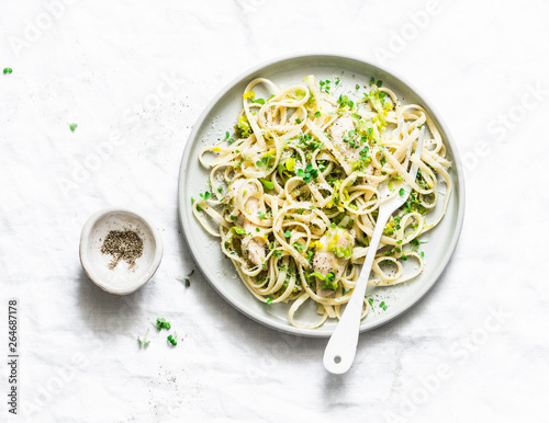 Chicken, leek, linguine pasta carbonara on a light background, top view