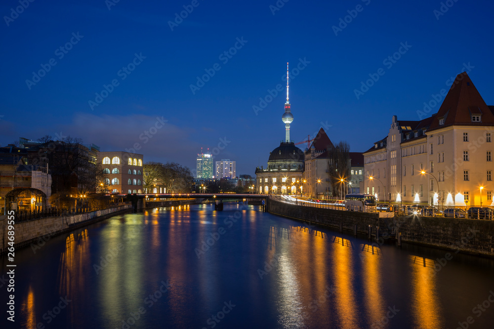Bode Museum and other buildings and their reflections on the Spree River in Berlin, Germany, at dusk. Fernsehturm TV Tower is in the background.