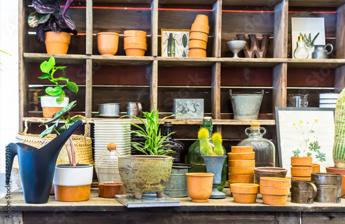 Working space and shelf with garden tools in cozy home garden on summer.