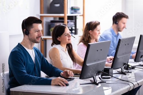 Wallpaper Mural Smiling Customer Service Executives Using Earphones Torontodigital.ca
