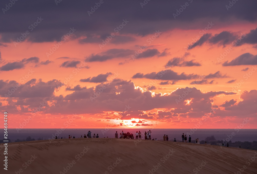 people enjoy sunrise in the white sand dunes, Muine, Vietnam