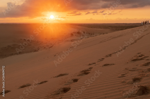 footprint in sand desert in sunrise