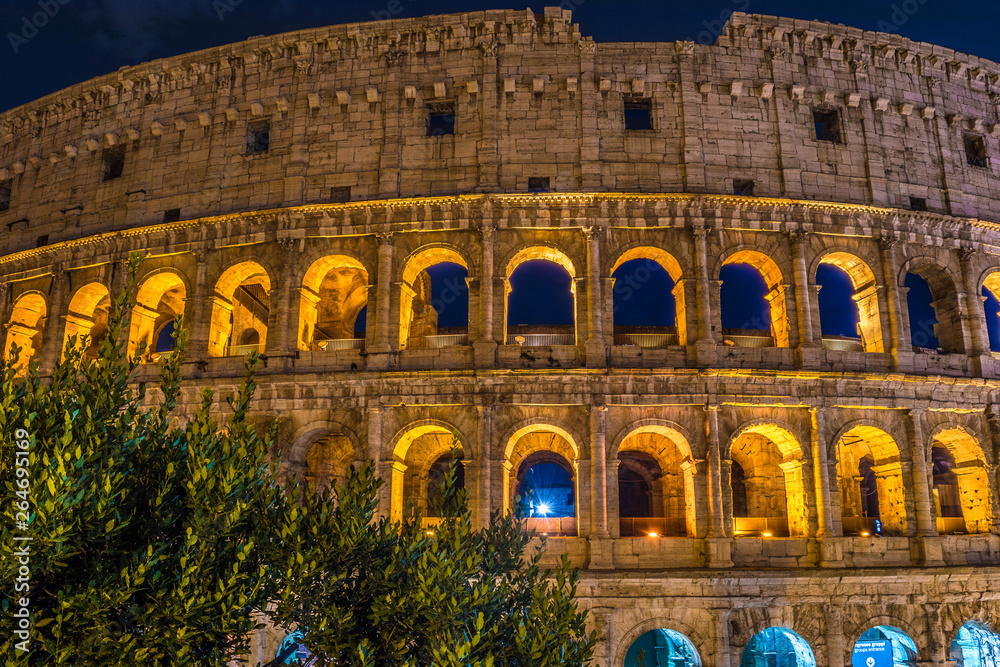 Roman Coliseum and its unmistakable luminous beauty at night in Rome - Italy